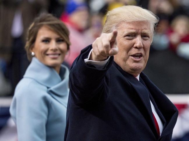 President Donald Trump, accompanied by first lady Melania Trump, points to members of the crowd as they walk in his inaugural parade on Pennsylvania Ave. outside the White House in Washington on January 20, 2017. Picture: AP