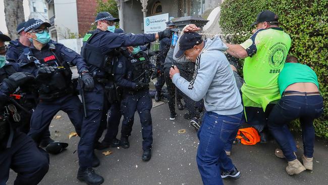 Markless protestors are sprayed by police. Picture: Alex Coppel