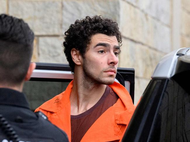 HOLLIDAYSBURG, PENNSYLVANIA - DECEMBER 10: Luigi Mangione is led into the Blair County Courthouse for an extradition hearing December 10, 2024 in Hollidaysburg, Pennsylvania. Mangione has been arraigned on weapons and false identification charges related to the fatal shooting of United Healthcare CEO Brian Thompson in New York City. Mangione is incarcerated in the State Correctional Institution in Huntingdon, Pennsylvania awaiting extradition to New York.   Jeff Swensen/Getty Images/AFP (Photo by JEFF SWENSEN / GETTY IMAGES NORTH AMERICA / Getty Images via AFP)