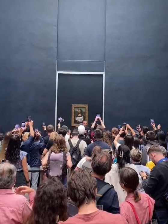 A large crowd watched as security cleaned the glass. Picture: Twitter