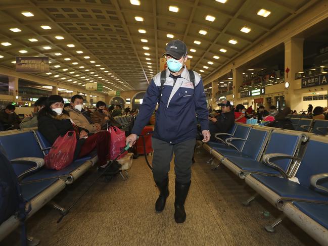 A worker sprays disinfectant at a train station in Wuhan in southern China's Hubei province. Picture: AFP