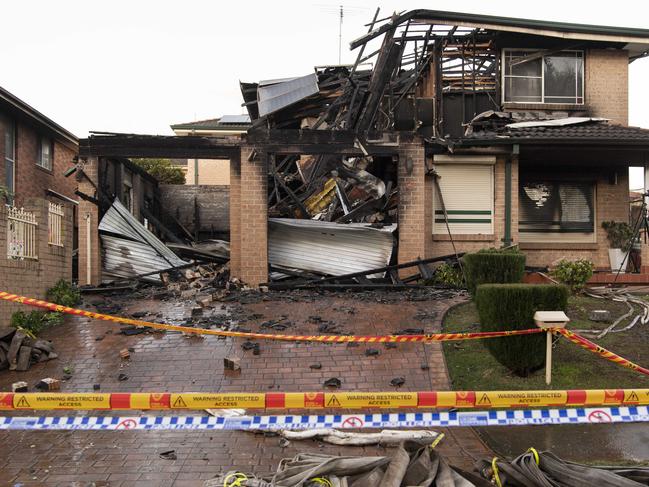 Police work at the scene of a fatal house fire. Picture: Monique Harmer