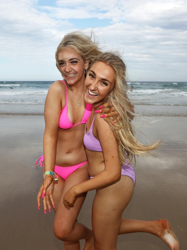 Mount St Michael's Schoolies Maddie Latham (Pink) and Ella Kemp (purple) at Surfers Paradise Beach on The Gold Coast. Photograph: Jason O'Brien / Sunday Mail