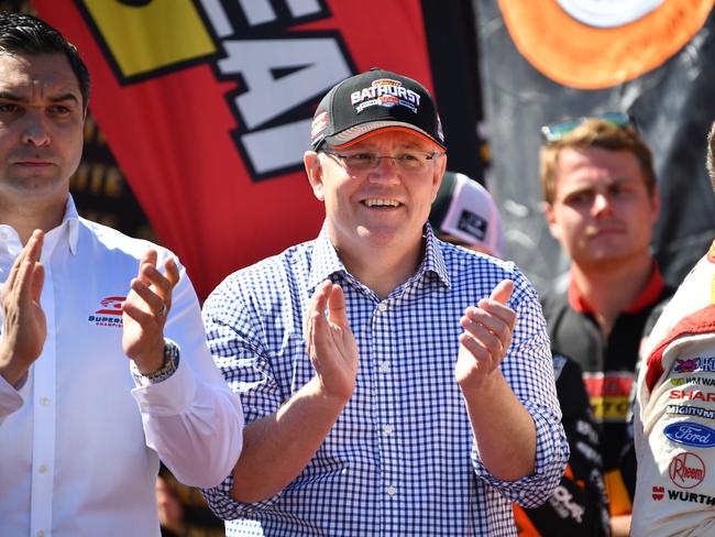 Australian Prime Minister Scott Morrison (centre) is seen during the Bathurst 1000 V8 Super Cars Championship at Mount Panorama Motor Racing Circuit in Bathurst, Sunday, October 7, 2018. The Bathurst 1000 is the most famed race in the V8 Super Car calendar, fought out over 1000kms, the event draws fans from all over the country to the New South Wales town of Bathurst. (AAP Image/Brendan Esposito) NO ARCHIVING,EDITORIAL USE ONLY