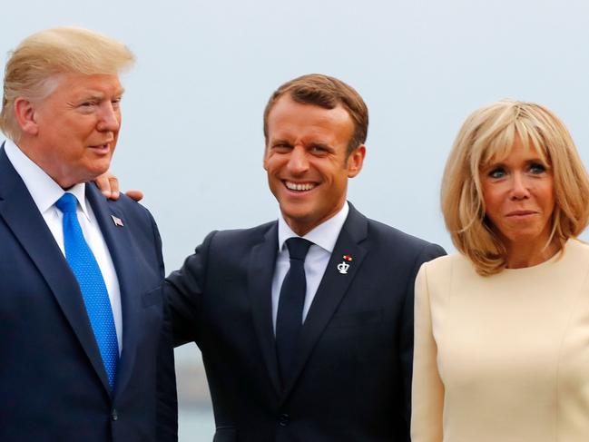 Donald Trump with French President Emmanuel Macron and his wife Brigitte Macron. Picture: AFP