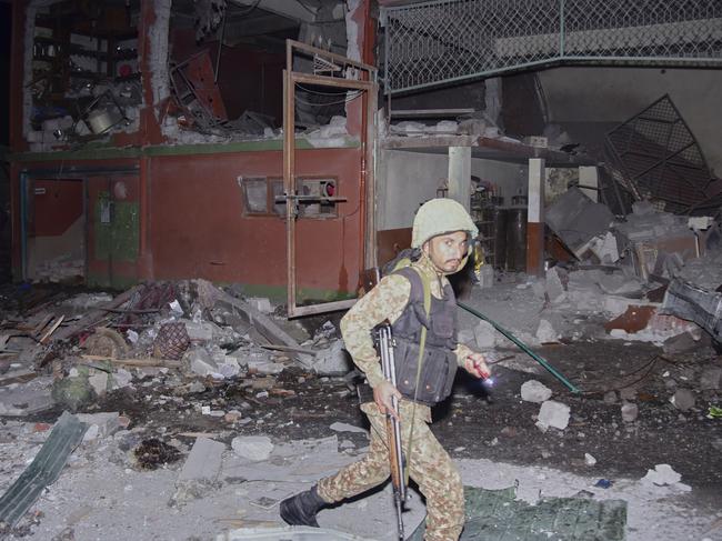 An army soldier examines a building damaged by a suspected Indian missile attack near Muzaffarabad, the capital of Pakistan controlled Kashmir, in Wednesday, May 7, 2025. (AP Photo/M.D. Mughal)