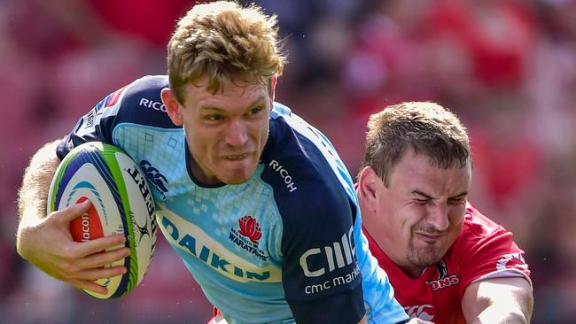 Bryce Hegarty of the Waratahs is tackled by Ruan Dreyer of the Emirates Lions during the SuperRugby match between Emirates Lions and Waratahs at the Emirates Airline Park-Johannesburg, on March 4, 2017 in Johannesburg. / AFP PHOTO / CHRISTIAAN KOTZE