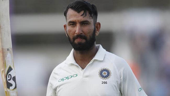 India's Cheteshwar Pujara walks off the pitch after his century.