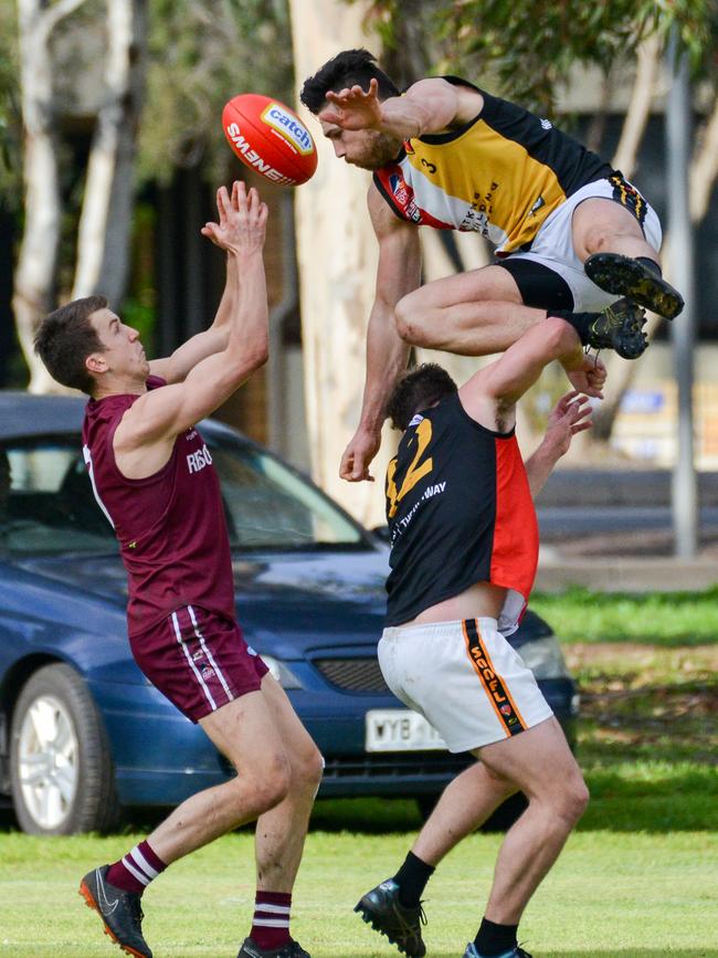 Jack Trengove marks as his Goodwood Saints opponents collide. Picture: Brenton Edwards