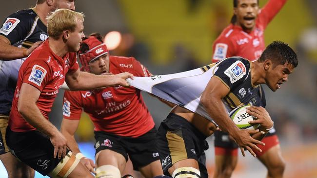 Jarrad Butler of the Brumbies is tackled by Ross Cronje of the Lions.