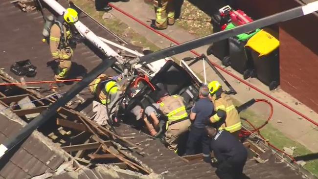 Emergency workers attempt to access the student pilot in the wake of the crash landing. Picture: Nine News