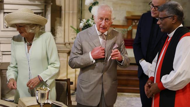 The royals sign the church bible. Picture: Rohan Kelly