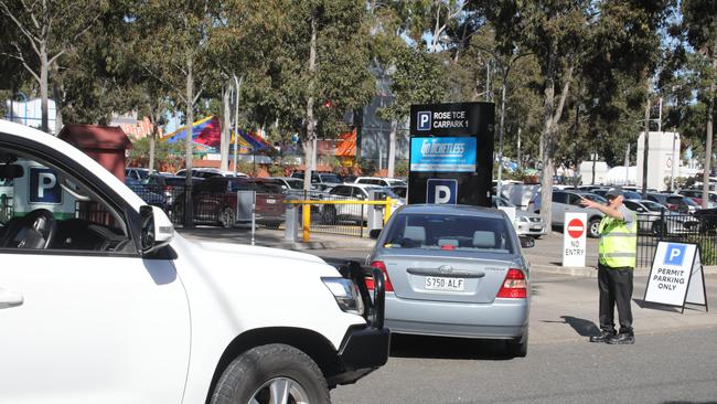 People lining up to try and get into a permit only park, and being told to go elsewhere. Picture: Dean Martin