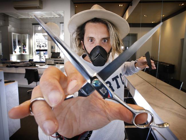 Hairdresser Joey Scandizzo will be the first to use new mask technology called Castle Grade Masks when he reopens his salon. Joey masked up with a G-series the reusable N95 masks and ready to cut.   Picture: David Caird