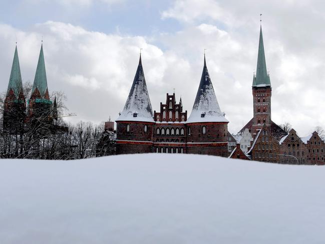 The Holsten Gate (C, Holstentor), landmark of the northwestern city of Luebeck, is covered in snow on February 27, 2018. A blast of Siberian weather dubbed “The Beast from the East” sent temperatures plunging across much of Europe. Picture AFP