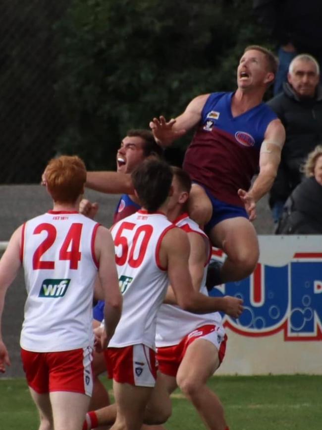 Horsham Demons player Brad Hartigan launches himself for a mark in his 300th match in the Wimmera league. Picture: Lauren McKinnon