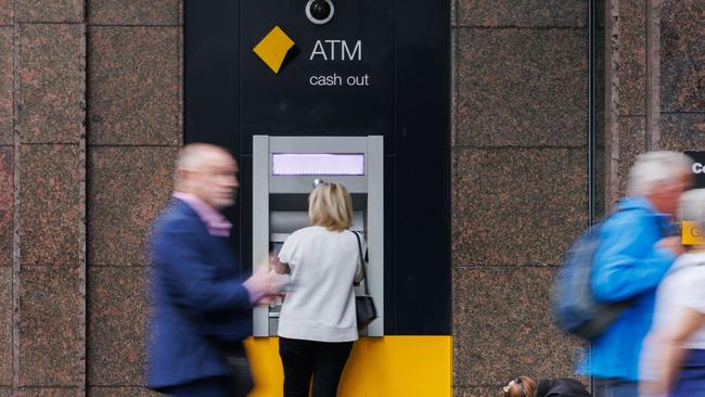 SYDNEY, AUSTRALIA - NewsWire Photos MAY 10 2024. GENERIC. A woman begs for money next to a Commonwealth Bank ATM in Sydney. Economy, cost of living, budget, poverty, homeless, banking. Picture: NCA NewsWire / Max Mason-Hubers