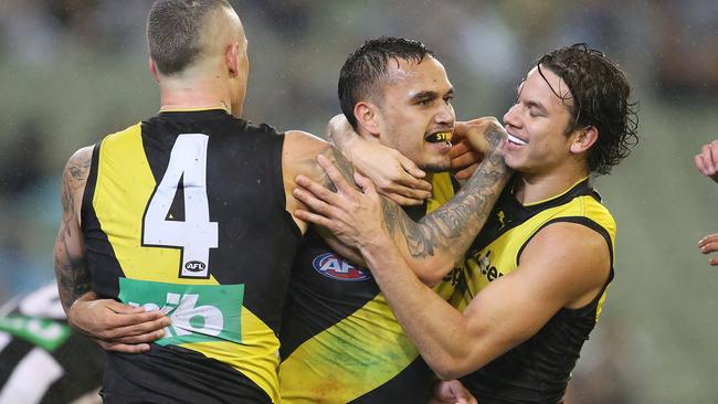 Sydney Stack celebrates a goal with Dustin Martin and Daniel Rioli. Pic: Michael Klein