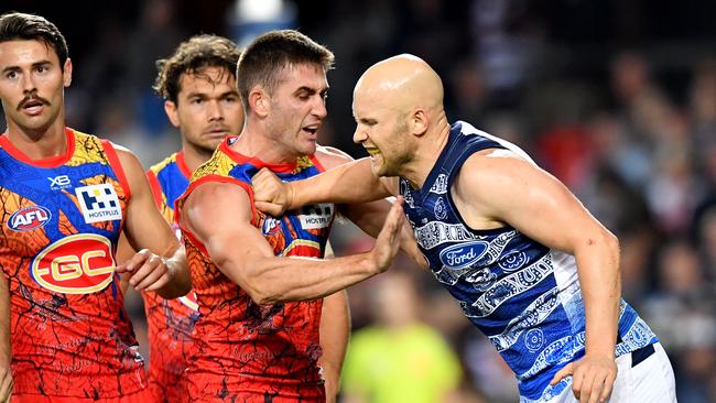 Gary Ablett (right) scuffles with Gold Coast midfielder Anthony Miles. Picture: AAP Image/Darren England.