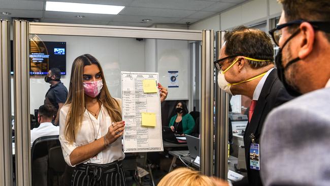 Electoral workers inspect a ballot during the vote-by-mail ballot scanning process at the Miami-Dade County Election Department in Florida. Picture: AFP