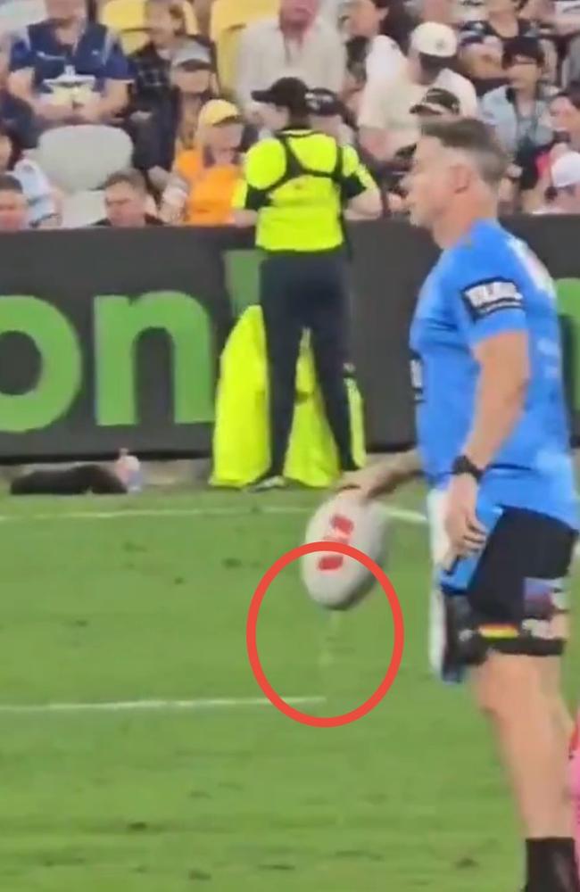 Water can been seen dripping from the ball as Shane Elford prepares to hand it to Dylan Edwards for the kick off.