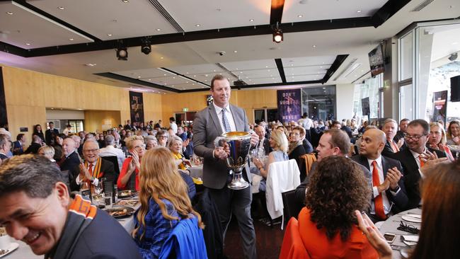 Former Geelong player Steve Johnson presents the premiership trophy. Picture: Getty