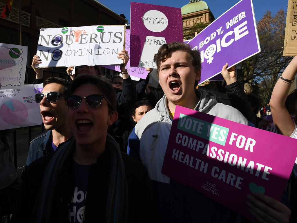 Pro-choice advocates hold placards during a rally outside the New South Wales Parliament house in Sydney, Tuesday, August 6, 2019. (AAP Image/Joel Carrett)