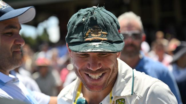 The case of Warner’s missing baggy green has finally been solved. (Photo by Saeed KHAN / AFP)