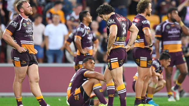 Broncos players look dejected after their loss to the Dragons. Photo: Getty Images