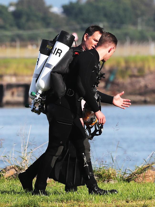 Police divers investigate. Picture: Peter Lorimer