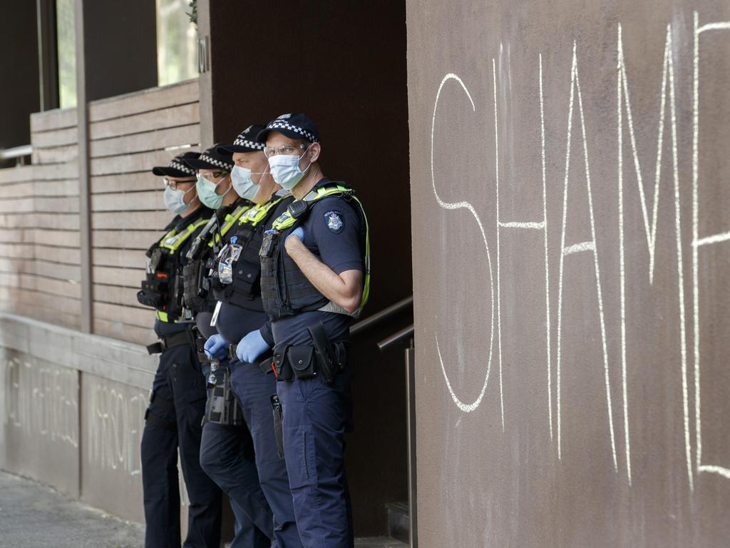 Police keep a close watch on a refugee protest outside the Park Hotel in Carlton. Picture: NCA NewsWire / David Geraghty