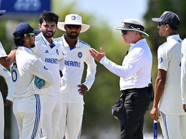 MACKAY, AUSTRALIA - NOVEMBER 03: A match umpire speaks to players of India A before commencement of play during day four of the match between Australia A and India A at Great Barrier Reef Arena on November 03, 2024 in Mackay, Australia. (Photo by Albert Perez/Getty Images)