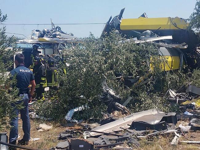 A policeman standing near crashed carriages after a head-on collision between two trains between Ruvo and Corato, in the southern Italian region of Puglia. Picture: AFP