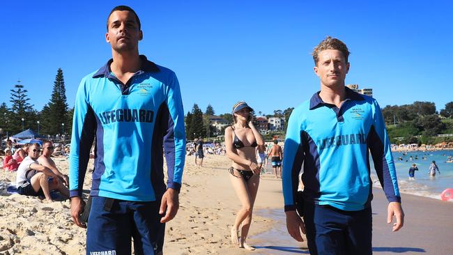 Lifeguards Leroy Bellanto, left, and Jake Murmi keep a close eye on beachgoers during their patrol of Sydney’s Coogee beach. Picture: John Feder