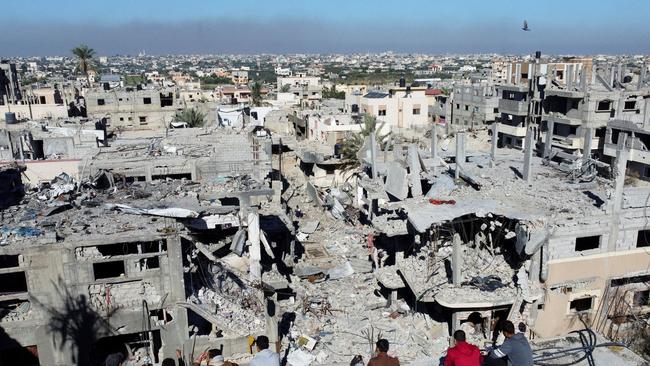 Palestinians look at homes destroyed during the conflict at the Khan Younis refugee camp, in the southern Gaza Strip. Picture: Mohammed Salem/Reuters