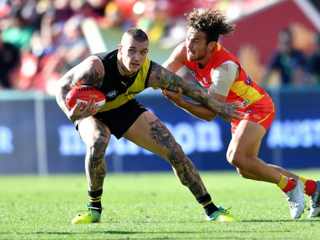 Dustin Martin of the Tigers (left) is tackled by Jarrod Harbrow of the Suns during the Round 21 AFL match between the Gold Coast Suns and the Richmond Tigers at Metricon Stadium on the Gold Coast, Saturday, August 11, 2018. Picture: AAP Image/Darren England