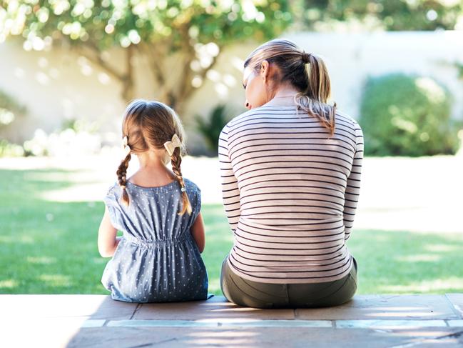 Rearview shot of a young woman and her daughter having a conversation on the porch