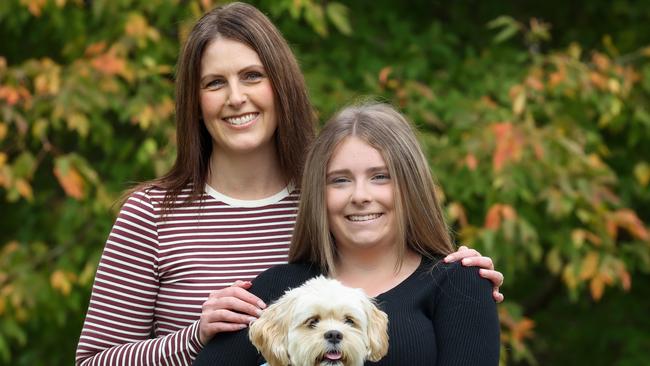 Taya, 16, was finally diagnosed with endometriosis after numerous trips to hospital. Taya is pictured with her mother Nicole and their pet dog Marley. Picture: Ian Currie