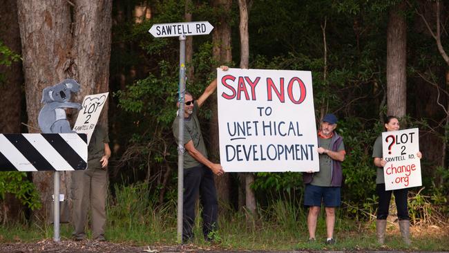 LONG BATTLE: People holding up signs at the proposed location of the 57-lot development in April last year.