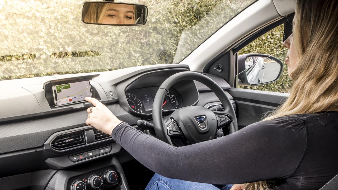 Dacia Sandero owners clip their phone into the dashboard to access digital features.