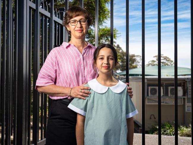 Jenny Dulimov with her daughter Madeleine, 9, outside Girraween Public School where demountable classrooms will finally be replaced with a brand new complex. Picture: Tom Parrish