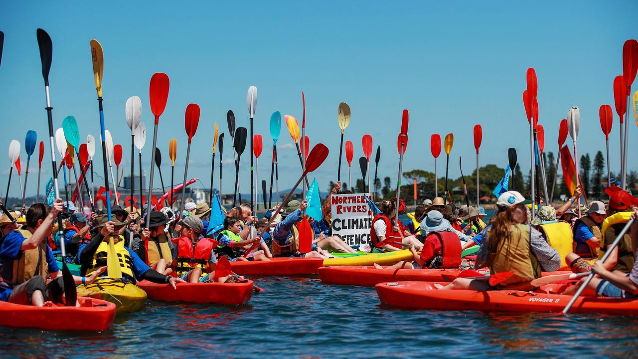 People take to the water at Newcastle’s coal port in a historic peaceful protest for climate action, highlighting the nation’s struggle with coal reliance amid emissions targets. Picture: Roni Bintang/Getty Images