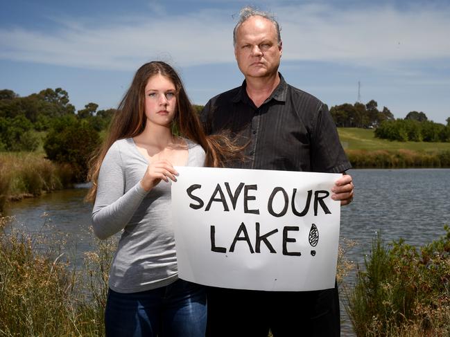 Mark Glazebrook, with his daughter Taya, is worried about the future of a lake next to the Blind Creek bike track. Picture: Kylie Else