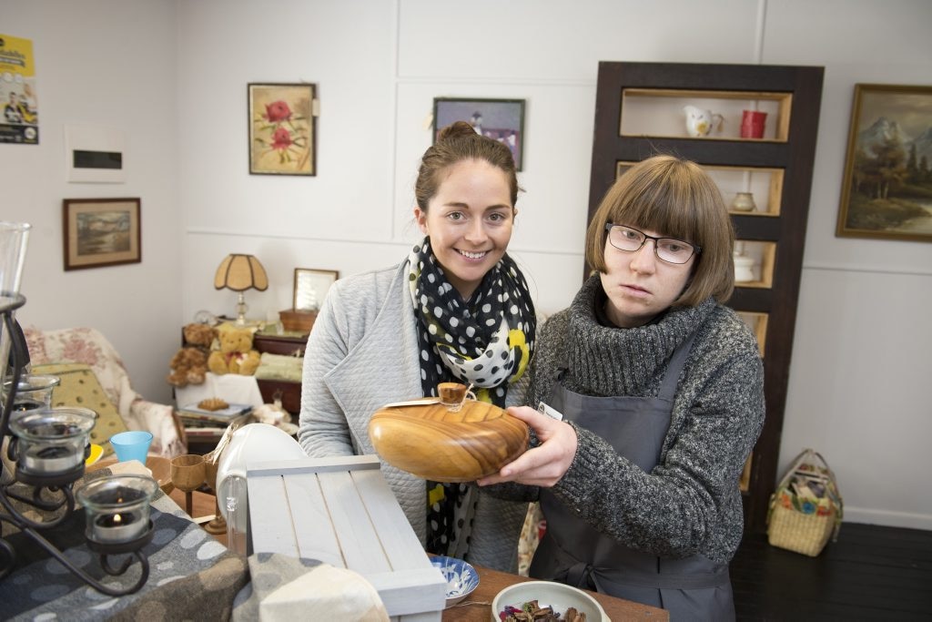 YellowBridge Queensland staff Brooke Currie (left) and client Katherine Lacey organise the shelves in the social enterprise op shop Collectables, Tuesday, June 7, 2016. Picture: Kevin Farmer