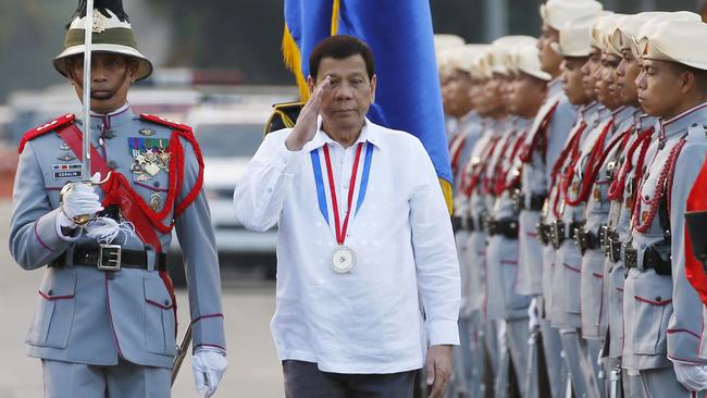 Philippine President Rodrigo Duterte salutes as he reviews troops. Source: AP