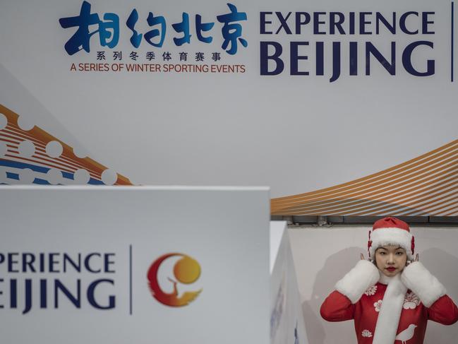 BEIJING, CHINA - APRIL 07: A Chinese hostess waits before the medal ceremony for the 3000 meter speed skating test event for the Beijing 2022 Winter Olympics at the National Speed Skating Oval on April 7, 2021 in Beijing, China. The events, which run from April 1-10, are the first tests at these venues for the games which are set to open on February 4, 2022.  (Photo by Kevin Frayer/Getty Images)