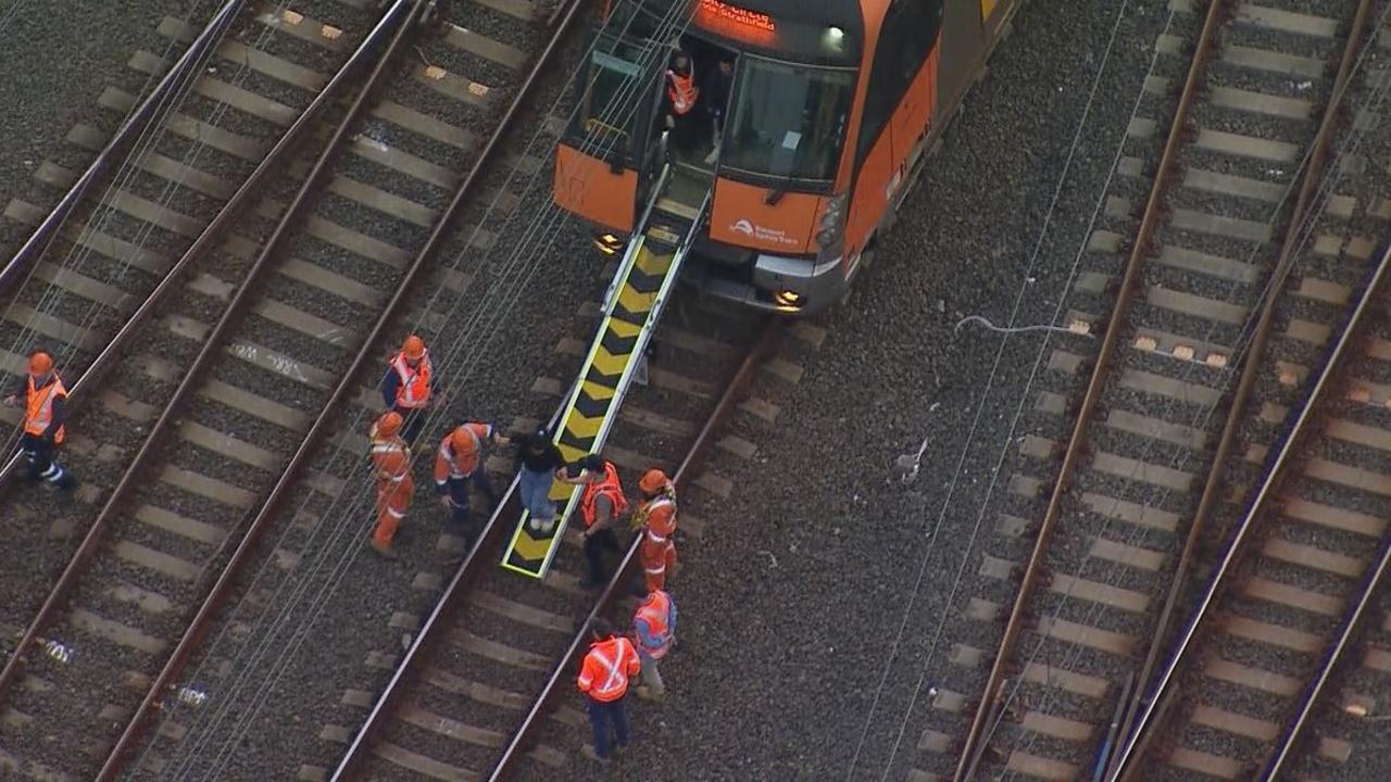 A stranded commuter is evacuated from the train. Picture: Nine News