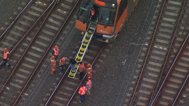 A stranded commuter is evacuated from the train. Picture: Nine News