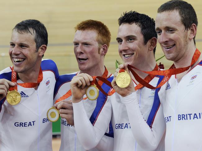 Cyclists (L-R) Paul Manning, Ed Clancy, Geraint Thomas and Bradley Wiggins of Great Britain pose for photographers after winning the gold medal in the men's team pursuit track final at the Beijing 2008 Olympics.