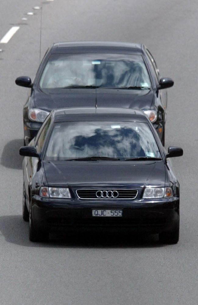 A motorist tailgating the vehicle in front.